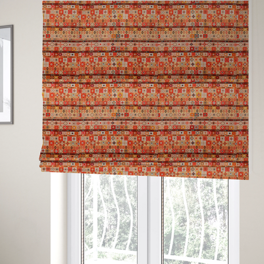 The fabric used to create these Roman blinds is a geometric woven fabric featuring horizontal rows of Aztec and tribal-inspired patterns in warm earthy tones of orange, red, yellow, beige, brown, and dark charcoal.