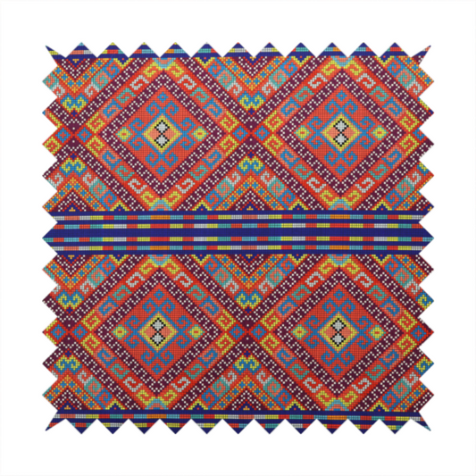 A vibrant geometric fabric featuring a detailed pixelated pattern of large interlocking diamonds in red, blue, purple, yellow, and turquoise, separated by horizontal striped bands of multi-coloured dots on a dark blue background, reminiscent of traditional beadwork or woven textile art.
