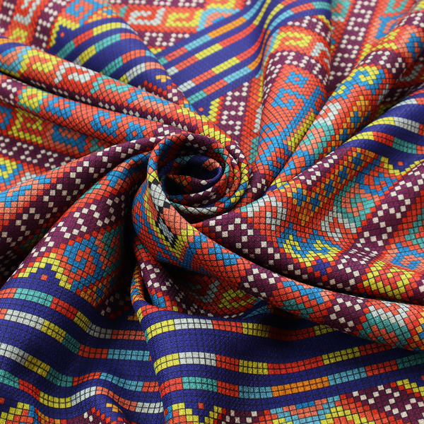 A vibrant geometric fabric featuring a detailed pixelated pattern of large interlocking diamonds in red, blue, purple, yellow, and turquoise, separated by horizontal striped bands of multi-coloured dots on a dark blue background, reminiscent of traditional beadwork or woven textile art.