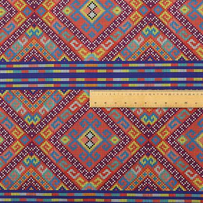 A vibrant geometric fabric featuring a detailed pixelated pattern of large interlocking diamonds in red, blue, purple, yellow, and turquoise, separated by horizontal striped bands of multi-coloured dots on a dark blue background, reminiscent of traditional beadwork or woven textile art.