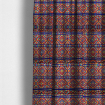The fabric used to create these made-to-measure curtains is a vibrant geometric fabric featuring a detailed pixelated pattern of large interlocking diamonds in red, blue, purple, yellow, and turquoise, separated by horizontal striped bands of multi-coloured dots on a dark blue background, reminiscent of traditional beadwork or woven textile art.