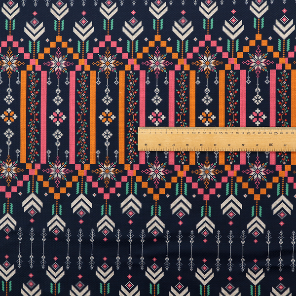 A dark navy blue fabric featuring a repeating geometric pattern with rows of chevron arrows, starburst motifs, and vertical striped panels containing delicate floral vine designs in pink, orange, white, and turquoise.