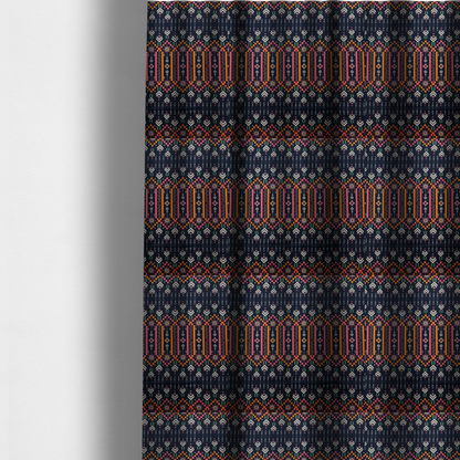 The fabric used to create these made-to-measure curtains is a dark navy blue fabric featuring a repeating geometric pattern with rows of chevron arrows, starburst motifs, and vertical striped panels containing delicate floral vine designs in pink, orange, white, and turquoise.