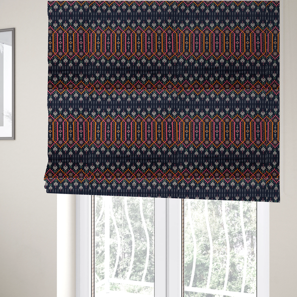 The fabric used to create these Roman blinds is a dark navy blue fabric featuring a repeating geometric pattern with rows of chevron arrows, starburst motifs, and vertical striped panels containing delicate floral vine designs in pink, orange, white, and turquoise.