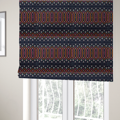 The fabric used to create these Roman blinds is a dark navy blue fabric featuring a repeating geometric pattern with rows of chevron arrows, starburst motifs, and vertical striped panels containing delicate floral vine designs in pink, orange, white, and turquoise.