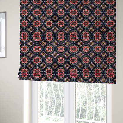 The fabric used to create these Roman blinds is a repeating folk-art textile design featuring alternating rows of stylized pink floral blossoms and intricate diamond-shaped geometric motifs.