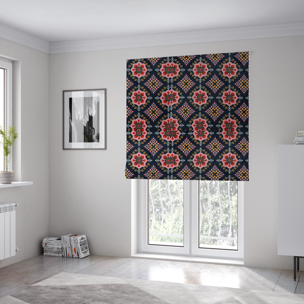 The fabric used to create these Roman blinds is a repeating folk-art textile design featuring alternating rows of stylized pink floral blossoms and intricate diamond-shaped geometric motifs.
