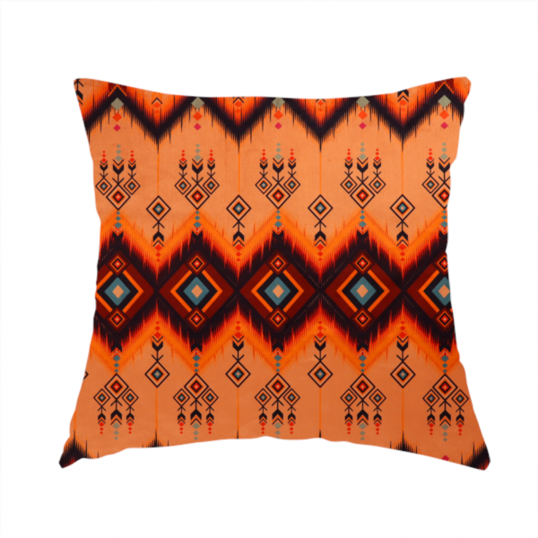 The fabric used to create this handmade cushion is an Aztec-inspired tribal ikat fabric featuring horizontal bands of sharp zigzags and diamond motifs.