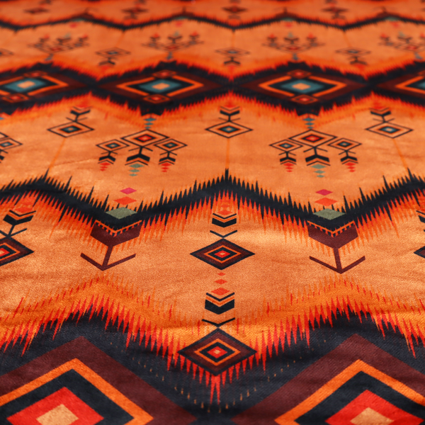 An Aztec-inspired tribal ikat fabric featuring horizontal bands of sharp zigzags and diamond motifs.