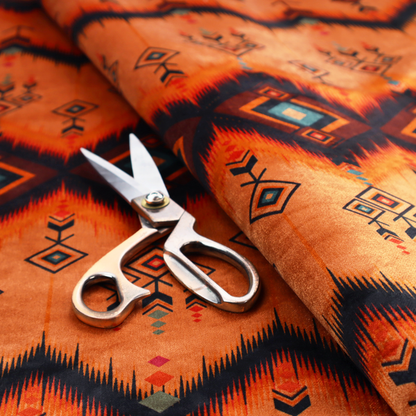 An Aztec-inspired tribal ikat fabric featuring horizontal bands of sharp zigzags and diamond motifs.
