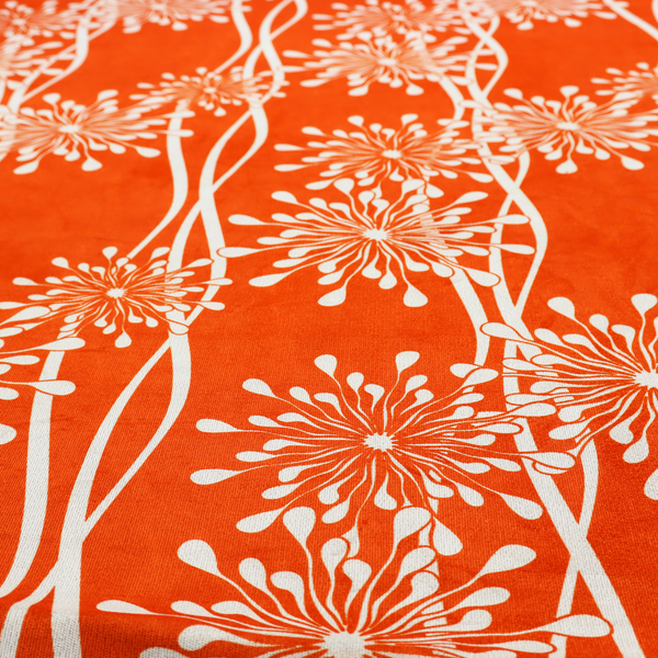 A modern botanical fabric featuring abstract, starburst floral or dandelion motifs paired with vertical wavy lines.
