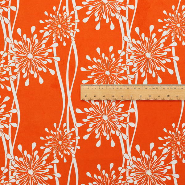 A modern botanical fabric featuring abstract, starburst floral or dandelion motifs paired with vertical wavy lines.