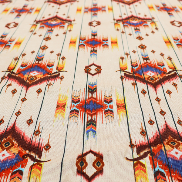An off-white fabric featuring a vibrant Southwestern Aztec and ikat-style geometric pattern.