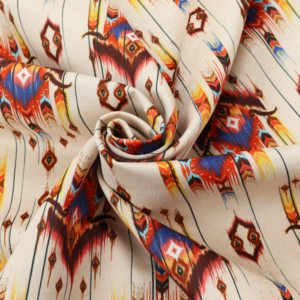 An off-white fabric featuring a vibrant Southwestern Aztec and ikat-style geometric pattern.