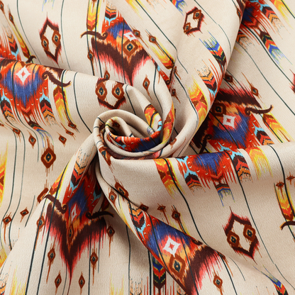 An off-white fabric featuring a vibrant Southwestern Aztec and ikat-style geometric pattern.