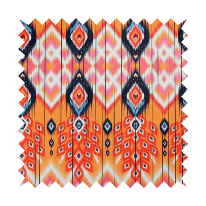 A vibrant orange fabric featuring a bold Southwestern Aztec and ikat-style geometric pattern.