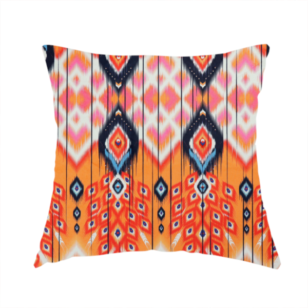 The fabric used to create this handmade cushion is a vibrant orange fabric featuring a bold Southwestern Aztec and ikat-style geometric pattern.