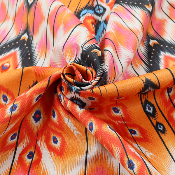 A vibrant orange fabric featuring a bold Southwestern Aztec and ikat-style geometric pattern.