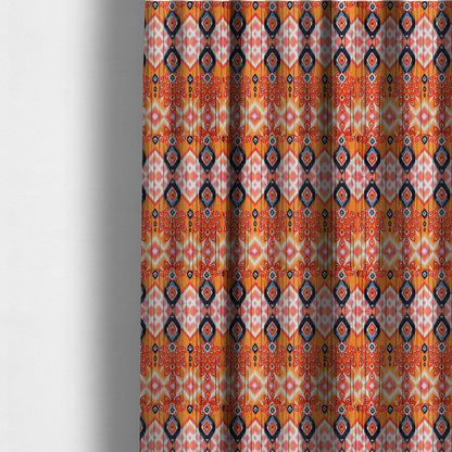 The fabric used to create these made-to-measure curtains is a vibrant orange fabric featuring a bold Southwestern Aztec and ikat-style geometric pattern.