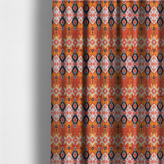 The fabric used to create these made-to-measure curtains is a vibrant orange fabric featuring a bold Southwestern Aztec and ikat-style geometric pattern.