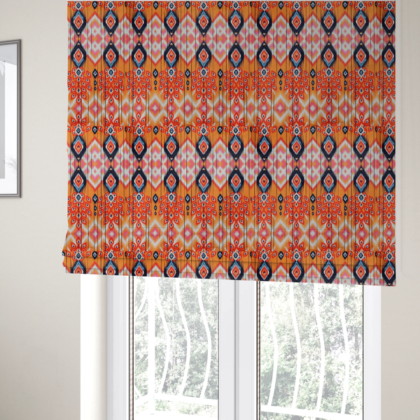 The fabric used to create these Roman blinds is a vibrant orange fabric featuring a bold Southwestern Aztec and ikat-style geometric pattern.