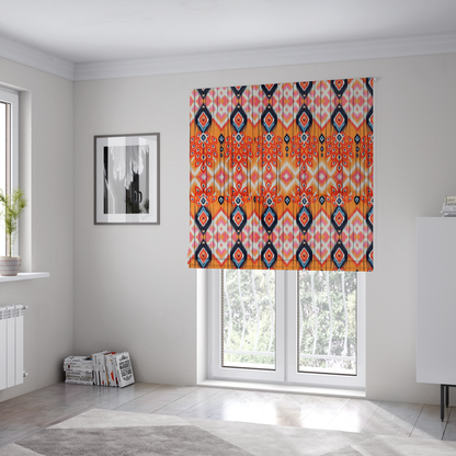 The fabric used to create these Roman blinds is a vibrant orange fabric featuring a bold Southwestern Aztec and ikat-style geometric pattern.