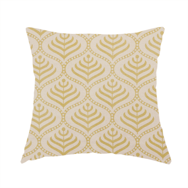 The fabric used to create this handmade cushion is a decorative, vintage-inspired textile pattern characterized by repeating ogival ogee arches filled with stylized leaf or feather motifs and dotted framing lines, rendered in gold or mustard yellow on a light neutral background.