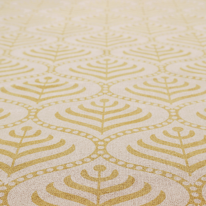 A decorative, vintage-inspired textile pattern characterized by repeating ogival ogee arches filled with stylized leaf or feather motifs and dotted framing lines, rendered in gold or mustard yellow on a light neutral background.