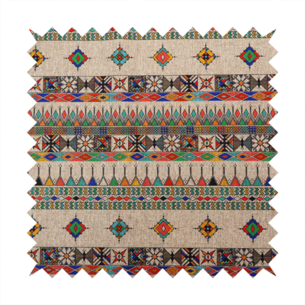A multi-coloured ethnic geometric fabric with repeating rows of colourful tribal diamonds, zigzags, and striped borders set against a light neutral background.