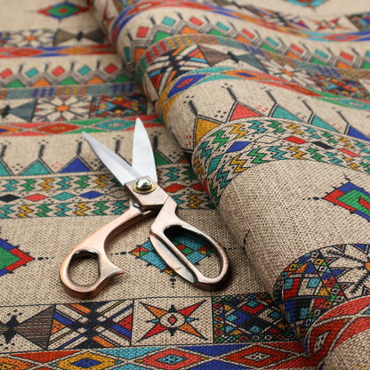 A multi-coloured ethnic geometric fabric with repeating rows of colourful tribal diamonds, zigzags, and striped borders set against a light neutral background.