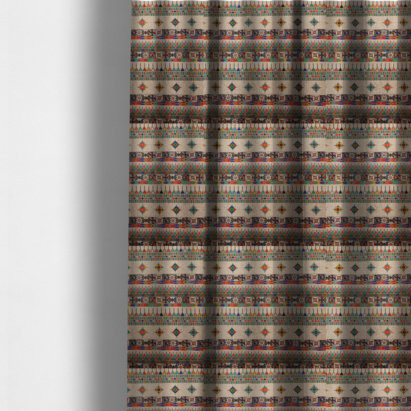 The fabric used to create these made-to-measure curtains is a multi-coloured ethnic geometric fabric with repeating rows of colourful tribal diamonds, zigzags, and striped borders set against a light neutral background.