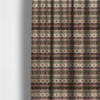 The fabric used to create these made-to-measure curtains is a multi-coloured ethnic geometric fabric with repeating rows of colourful tribal diamonds, zigzags, and striped borders set against a light neutral background.