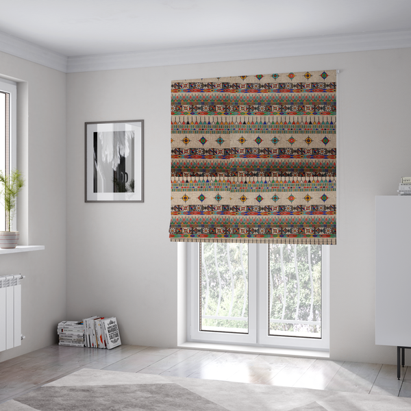 The fabric used to create these Roman blinds is a multi-coloured ethnic geometric fabric with repeating rows of colourful tribal diamonds, zigzags, and striped borders set against a light neutral background.