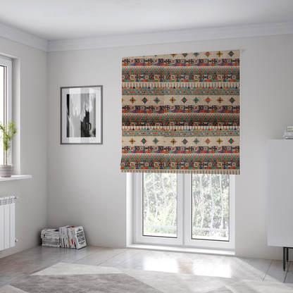The fabric used to create these Roman blinds is a multi-coloured ethnic geometric fabric with repeating rows of colourful tribal diamonds, zigzags, and striped borders set against a light neutral background.