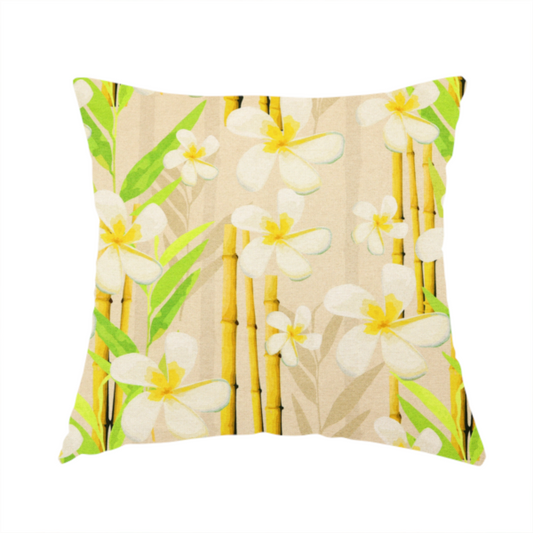 The fabric used to create this handmade cushion is a tropical botanical fabric pattern with white plumeria blossoms featuring yellow centres, paired with green leaves and yellow bamboo stalks, set against a light beige background.