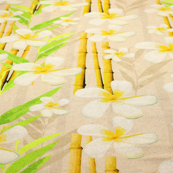 A tropical botanical fabric pattern with white plumeria blossoms featuring yellow centres, paired with green leaves and yellow bamboo stalks, set against a light beige background.