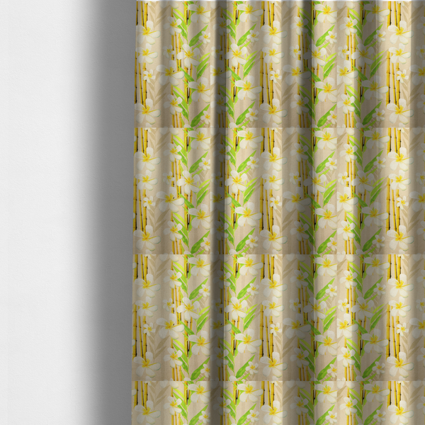 The fabric used to create these made-to-measure curtains is a tropical botanical fabric pattern with white plumeria blossoms featuring yellow centres, paired with green leaves and yellow bamboo stalks, set against a light beige background.