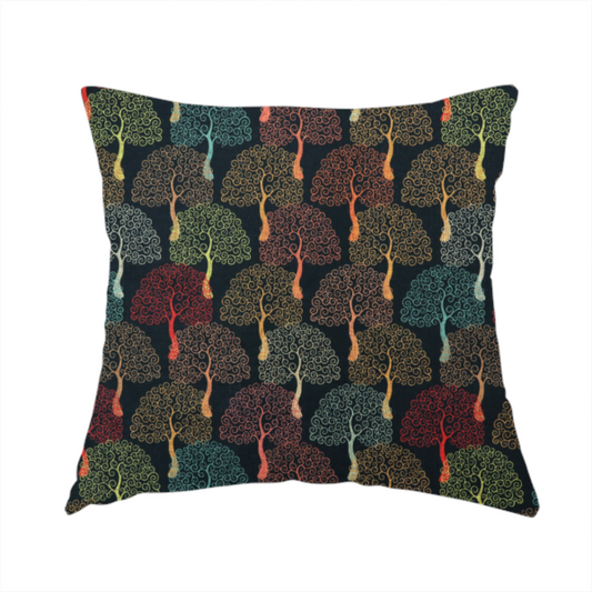 The fabric used to create this handmade cushion is a colourful, intricately patterned tree crowns in shades of red, teal, gold, and green on a dark background.