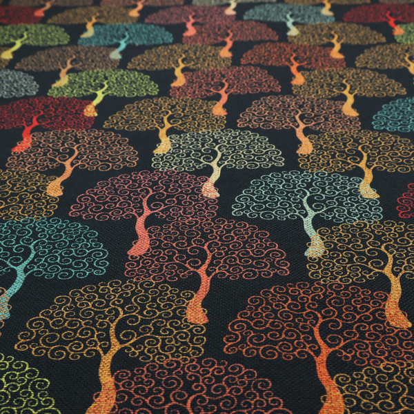 A colourful, intricately patterned tree crowns in shades of red, teal, gold, and green on a dark background.