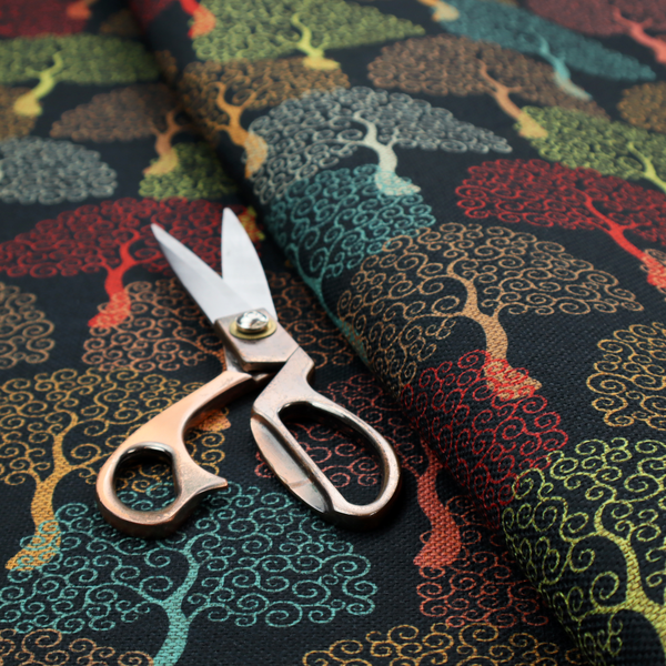 A colourful, intricately patterned tree crowns in shades of red, teal, gold, and green on a dark background.