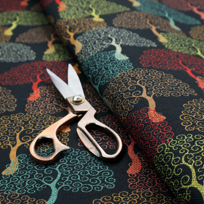 A colourful, intricately patterned tree crowns in shades of red, teal, gold, and green on a dark background.