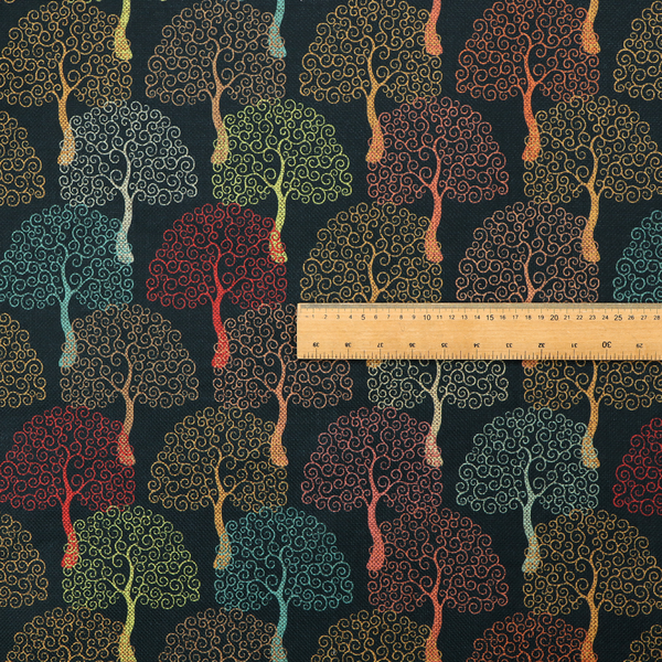 A colourful, intricately patterned tree crowns in shades of red, teal, gold, and green on a dark background.