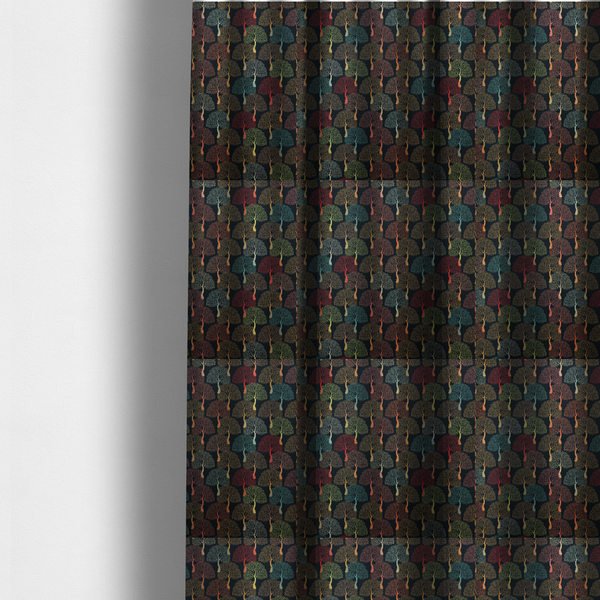 The fabric used to create these made-to-measure curtains is a colourful, intricately patterned tree crowns in shades of red, teal, gold, and green on a dark background.