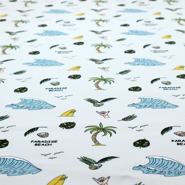 A playful pattern of ocean waves, palm trees, surfboards, and tropical leaves on a light background.