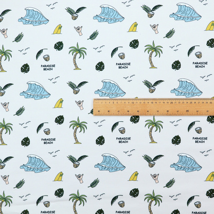 A playful pattern of ocean waves, palm trees, surfboards, and tropical leaves on a light background.