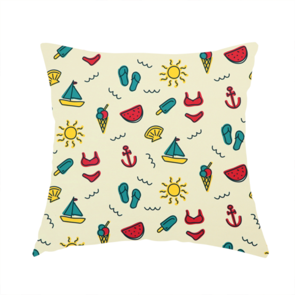 The fabric used to create this handmade cushion is a summer vacation pattern on a light cream background, featuring repeating rows of teal, yellow, and red beach icons including sailboats, bikinis, flip-flops, ice cream cones, suns, watermelons, anchors, and seashells.
