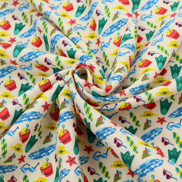A vibrant, repeating beach-themed pattern on a light cream background, featuring small illustrations of blue and white surfboards, red buckets, green swim flippers, sunglasses, yellow sunhats, starfishes, and popsicles.
