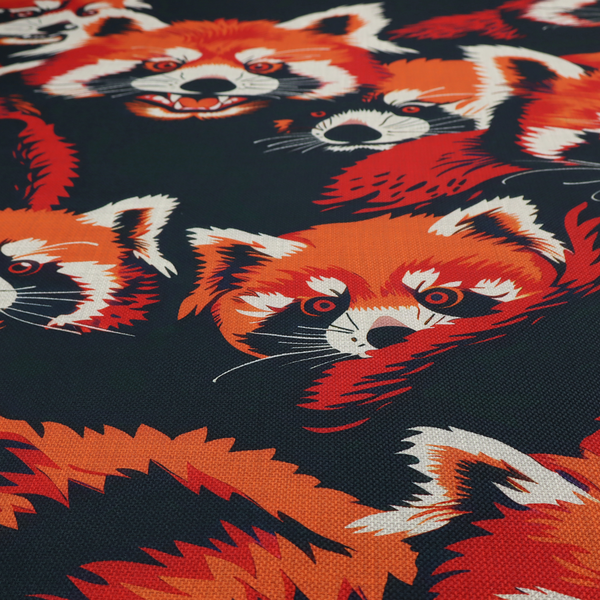 Fabric pattern featuring stylized, vibrant red pandas with white and black facial markings against a dark navy blue background.
