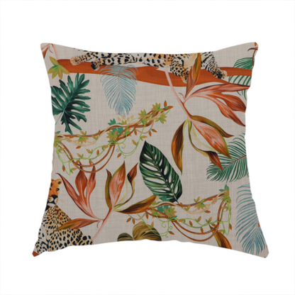 The fabric used to create this handmade cushion is a lounging leopards surrounded by vibrant tropical leaves, monstera fronds, and vines on a light-coloured background.