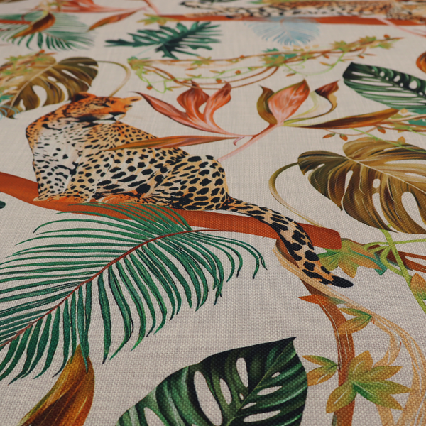 Fabric pattern featuring lounging leopards surrounded by vibrant tropical leaves, monstera fronds, and vines on a light-coloured background.